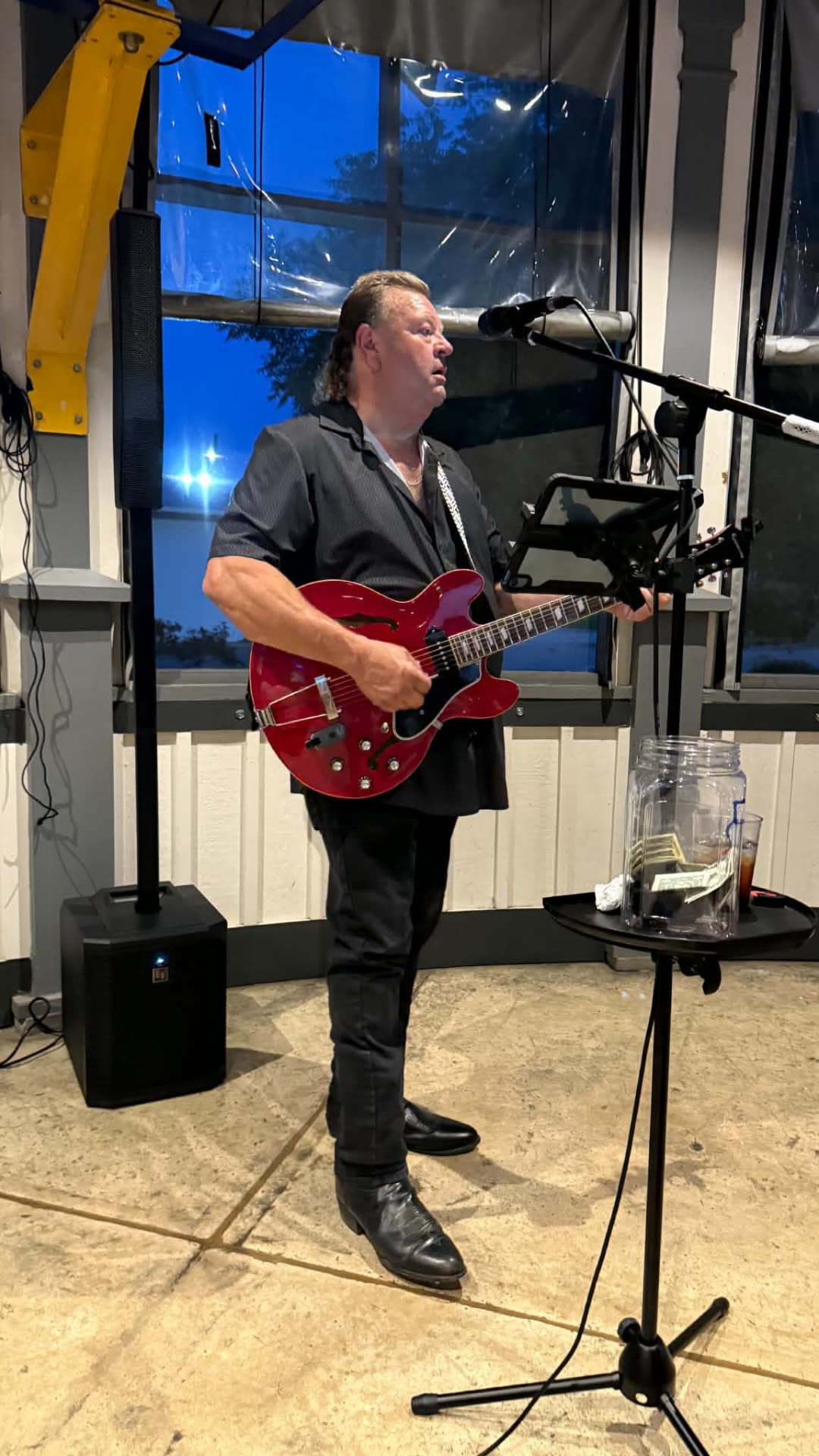 Shawn performing live with a red guitar